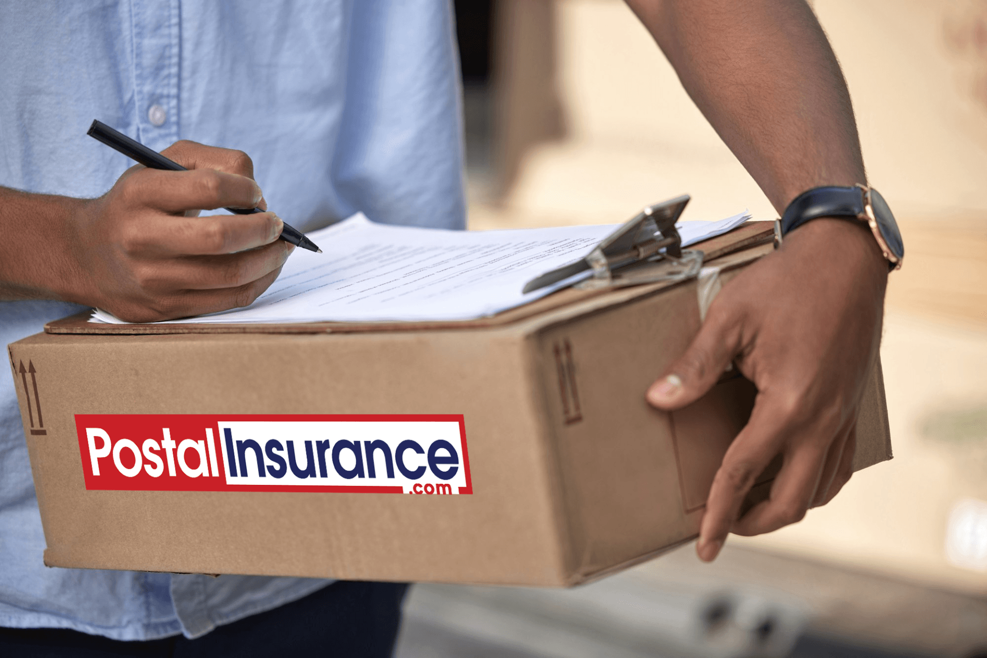 Man signing documents on a cardboard box with Postal Insurance logo on it